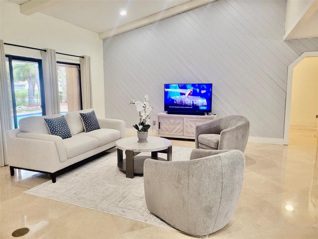 1581 Northwest 100th Way Plantation, FL 33322 - Photo 16 of 53 a living room with furniture and a flat screen tv