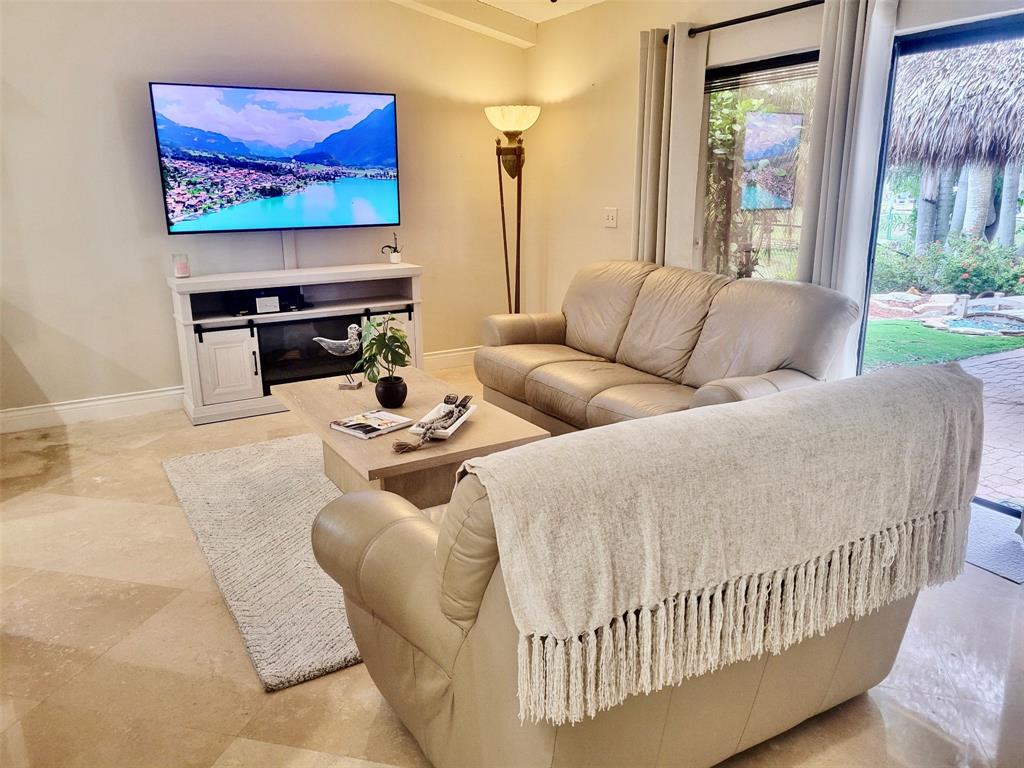 1581 Northwest 100th Way Plantation, FL 33322 - Photo 17 of 53 a living room with furniture and a flat screen tv