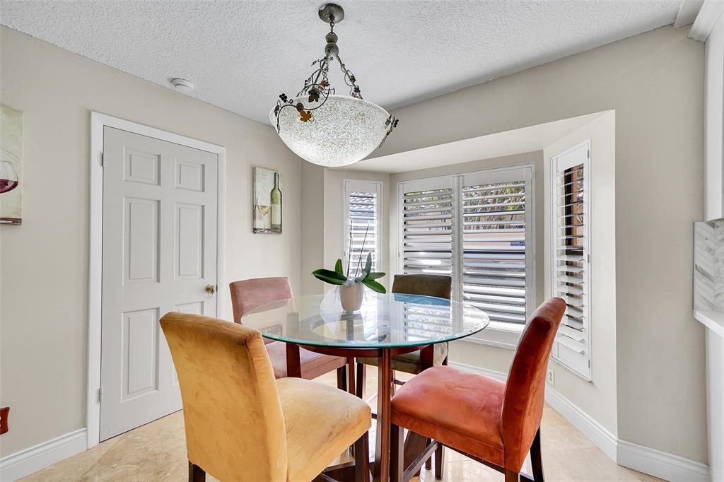 1581 Northwest 100th Way Plantation, FL 33322 - Photo 22 of 53 a view of a dining room with furniture window and wooden floor