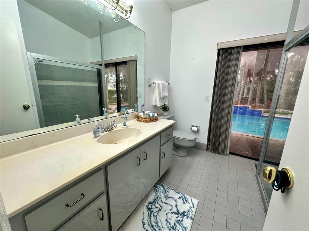 1581 Northwest 100th Way Plantation, FL 33322 - Photo 27 of 53 a spacious bathroom with a double vanity sink a mirror and a shower