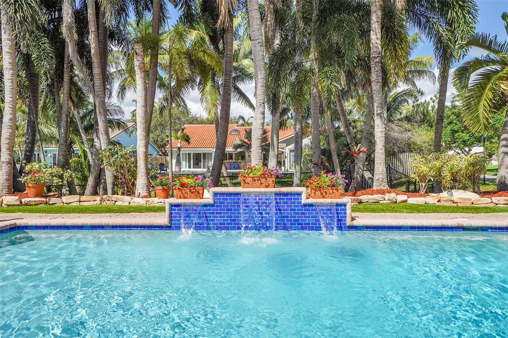 1581 Northwest 100th Way Plantation, FL 33322 - Photo 4 of 53 a view of swimming pool with lawn chairs and large trees
