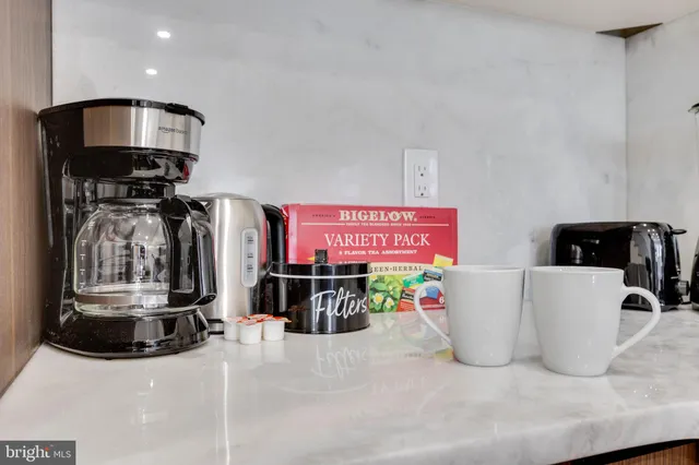 a view of living room with furniture and potted plant