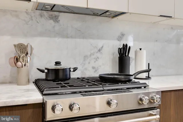 a stove top oven sitting inside of a kitchen