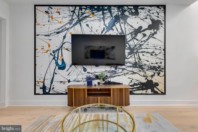 a view of entryway with furniture and wooden floor