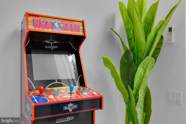 a living room with a flat screen tv and a bed