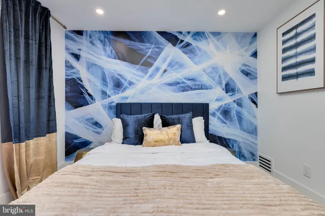 a bedroom with bed and wooden floor