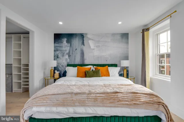 a bedroom with a bed and a lamp