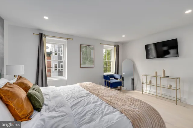 a bedroom with a bed and couch