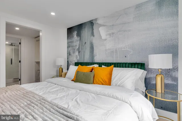 a bedroom with a bed and a flat screen tv