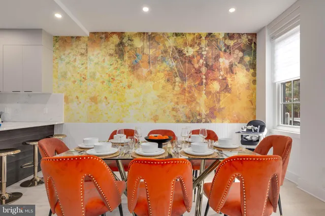 a dining room with furniture and a window