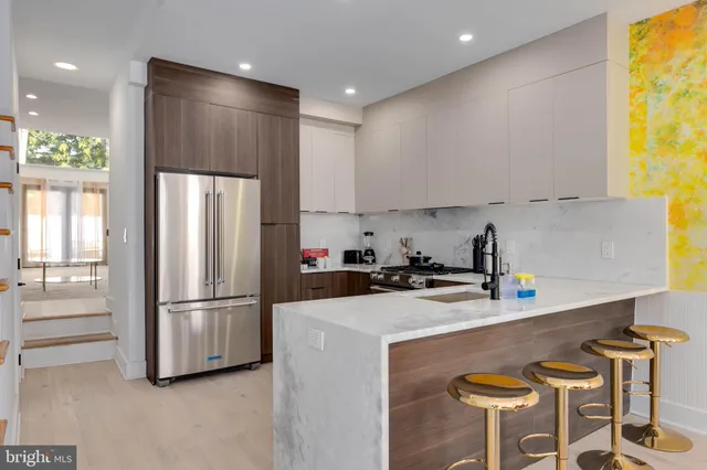 a kitchen with a refrigerator a stove a sink and a window