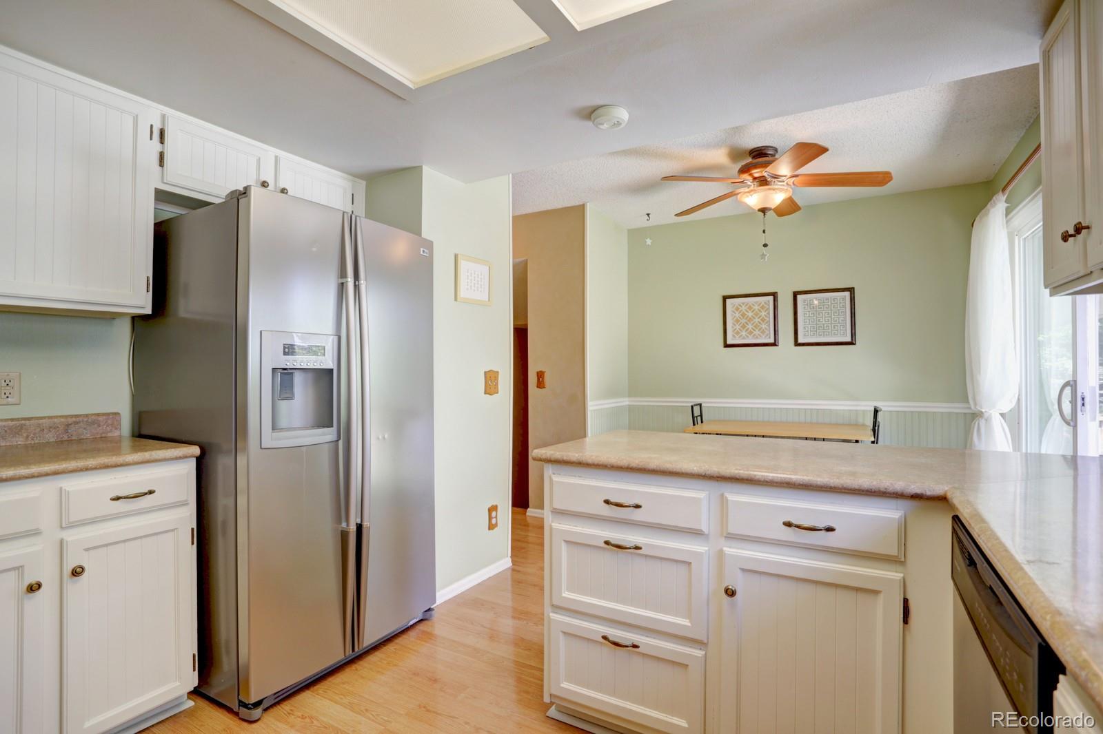 953 Fieldstone Place Highlands Ranch, CO 80126 - Photo 13 of 40 a kitchen with a refrigerator and a sink