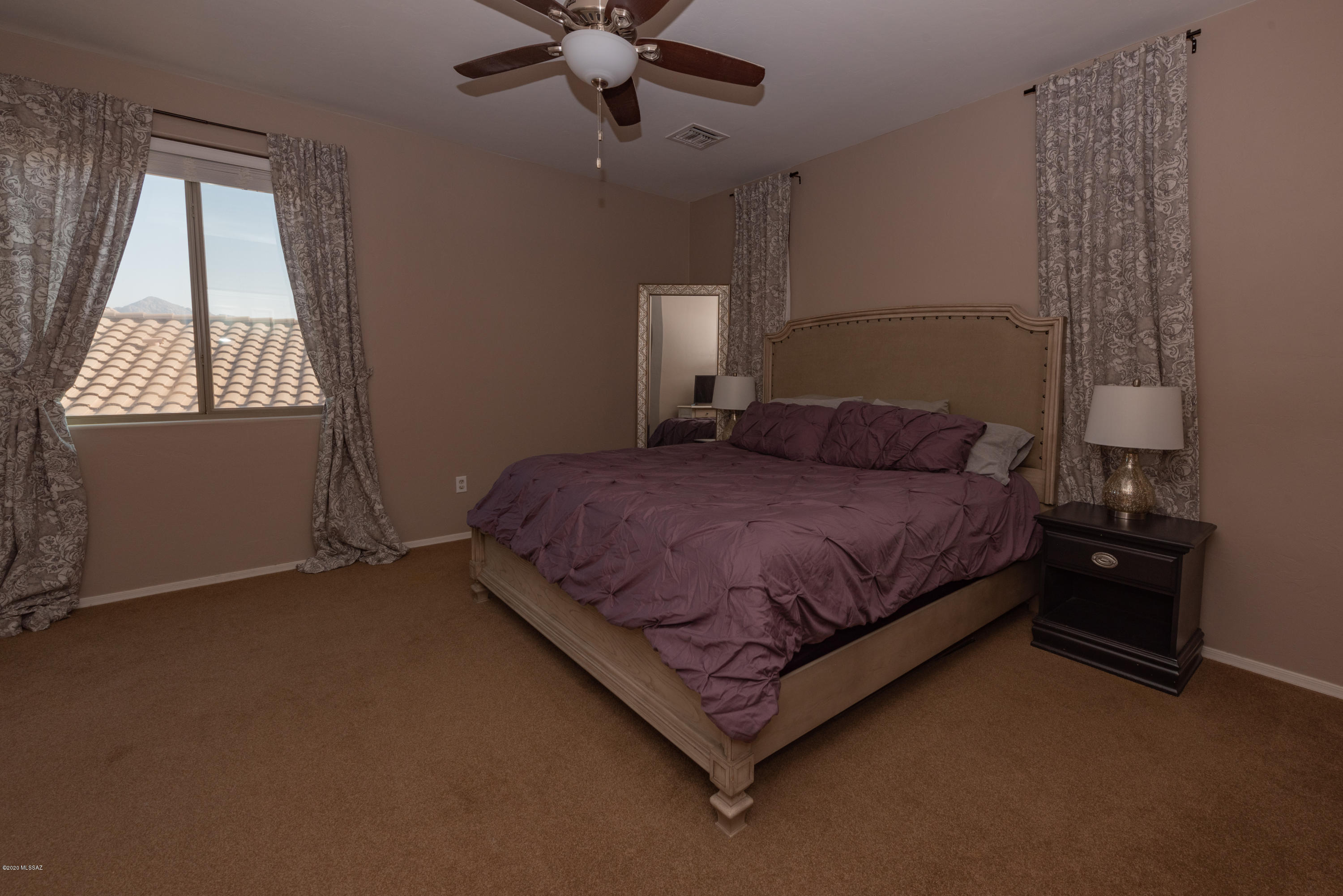 12910 Bloomington Loop Oro Valley, AZ 85755 - Photo 19 of 30 a bedroom with a bed and window