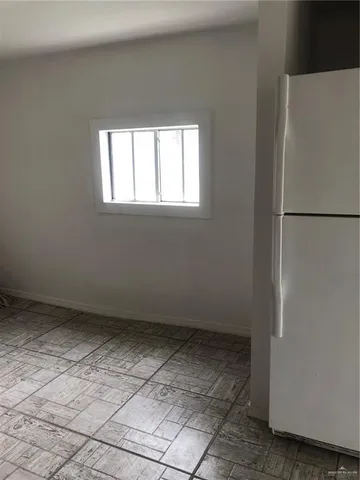 an empty room with a empty space and chandelier fan