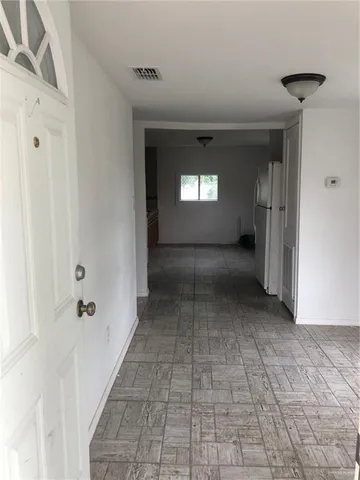 a kitchen with granite countertop a cabinets sink and stove