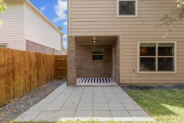a view of a house with a door and a rug