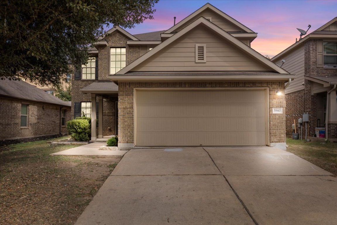 5940 Silver Screen Drive Austin, TX 78747 - Photo 4 of 17 a front view of a house with a yard and garage