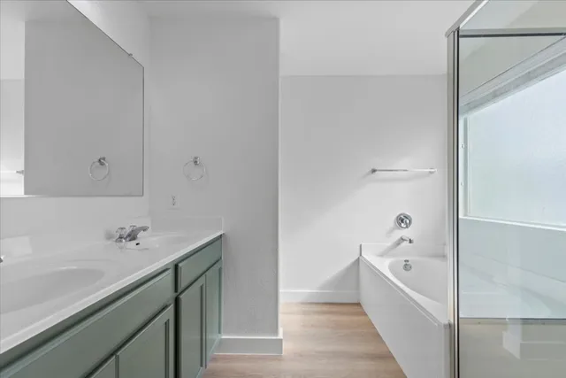 a bathroom with a bathtub and a sink