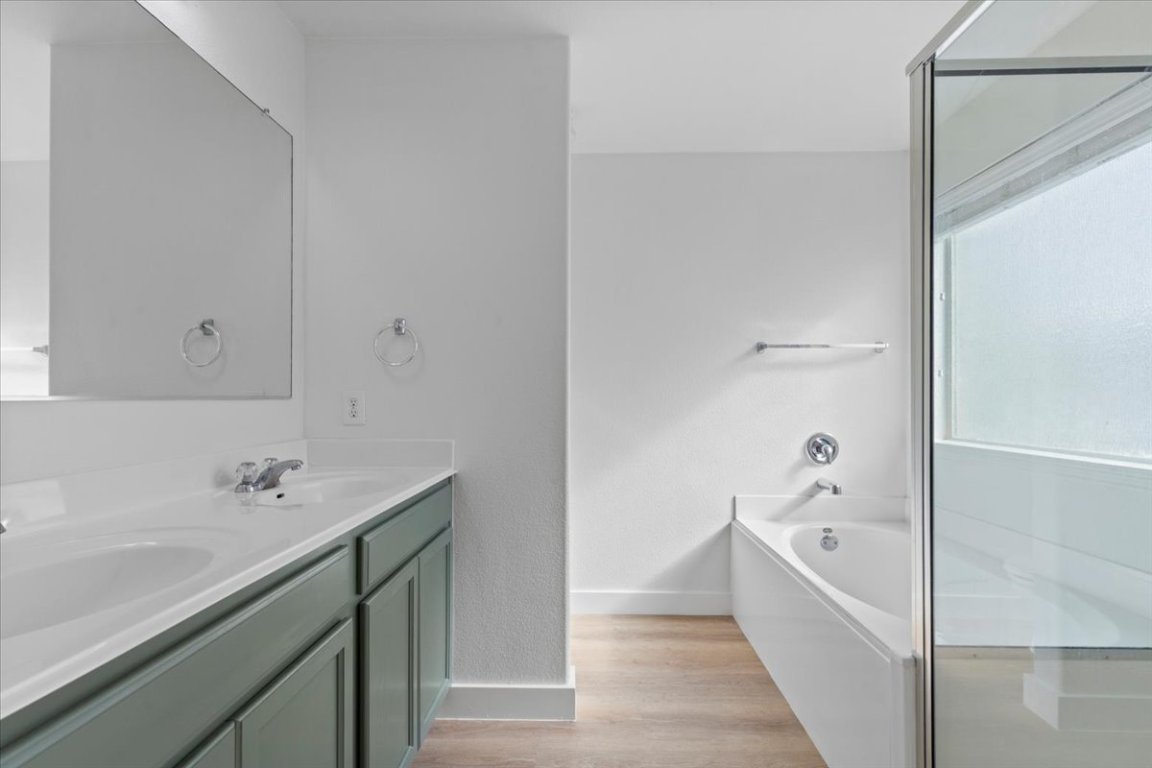 5940 Silver Screen Drive Austin, TX 78747 - Photo 9 of 17 a bathroom with a bathtub and a sink