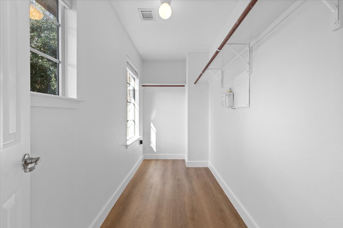 5940 Silver Screen Drive Austin, TX 78747 - Photo 10 of 17 Gorgeous Walk in closet with two bright windows and recently installed flooring. I imagine a lovely makeup table between the two windows...