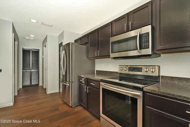 a kitchen with stainless steel appliances a refrigerator stove and microwave
