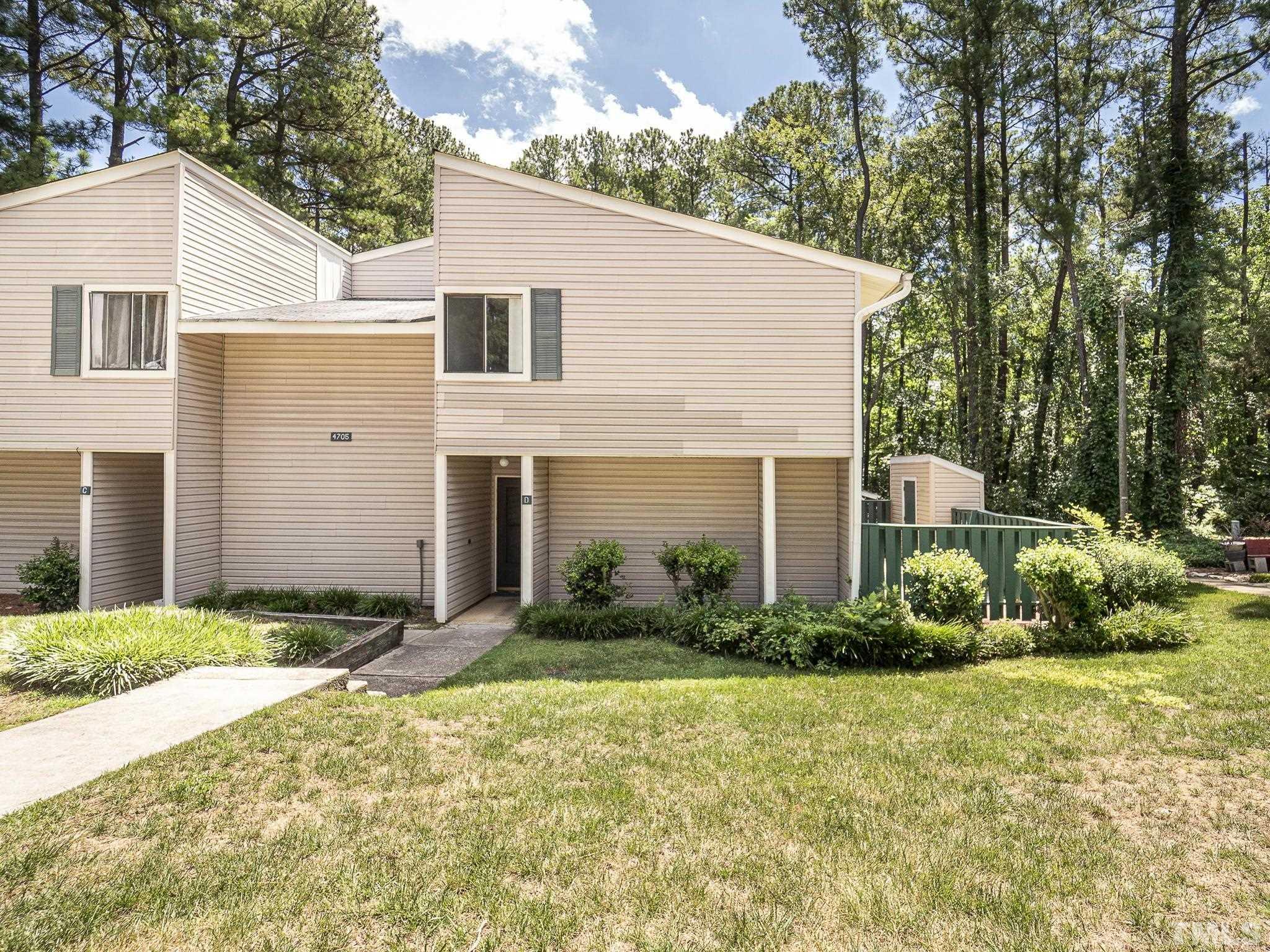 4705 Walden Pond Drive, Unit D Raleigh, NC 27604 - Photo 1 of 24 a front view of a house with garden