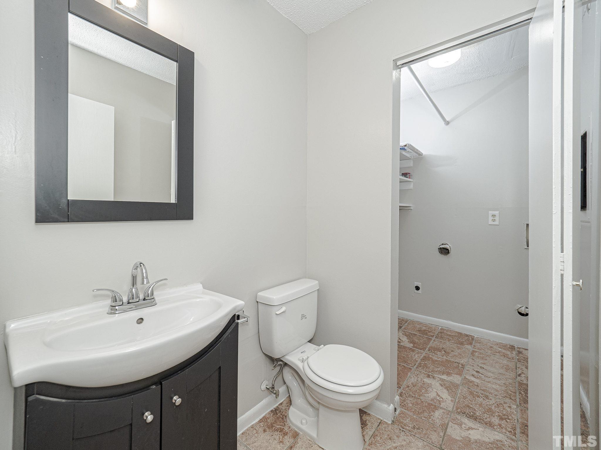 4705 Walden Pond Drive, Unit D Raleigh, NC 27604 - Photo 13 of 24 a bathroom with a sink toilet and shower