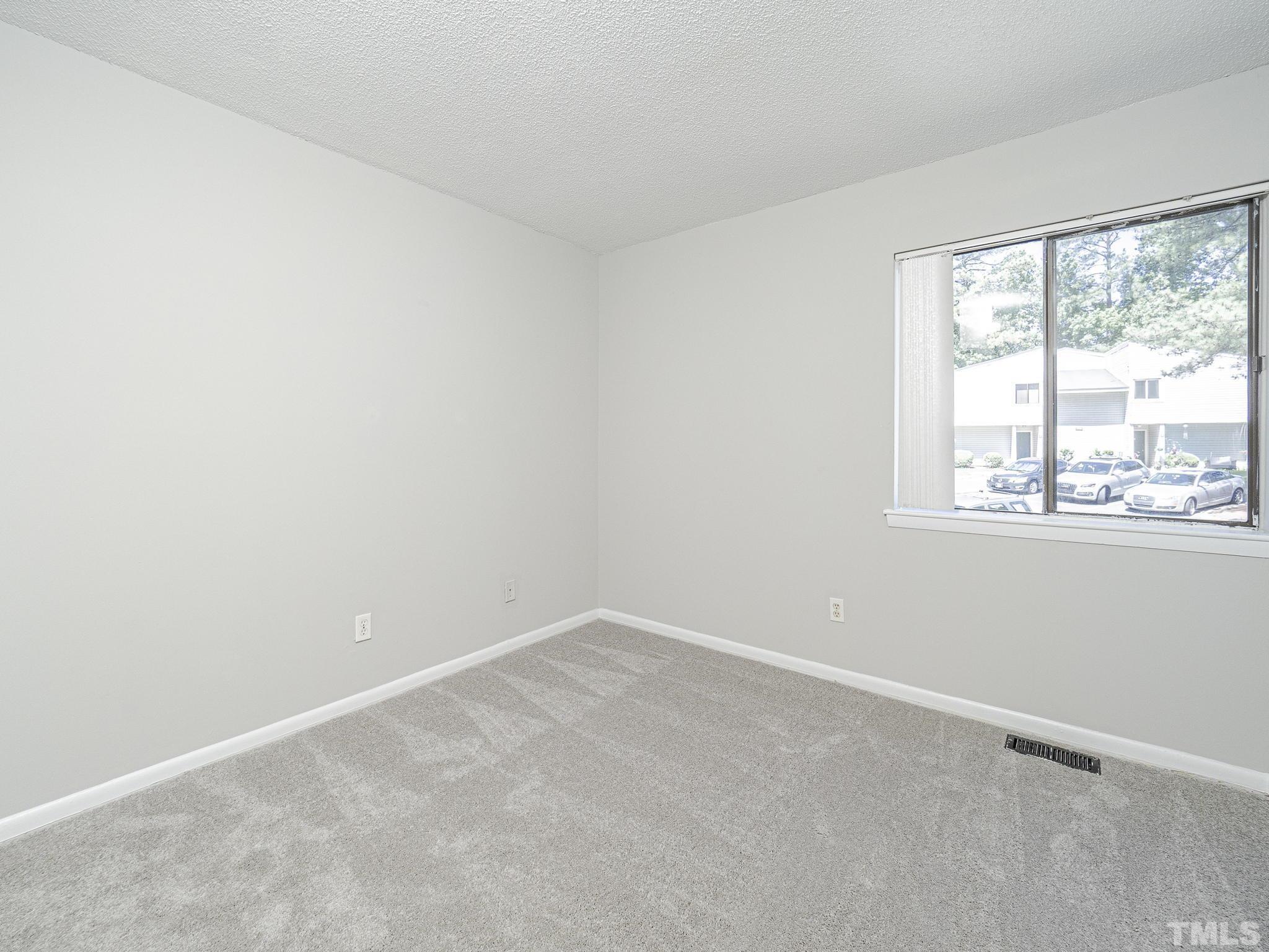 4705 Walden Pond Drive, Unit D Raleigh, NC 27604 - Photo 15 of 24 an empty room with a window