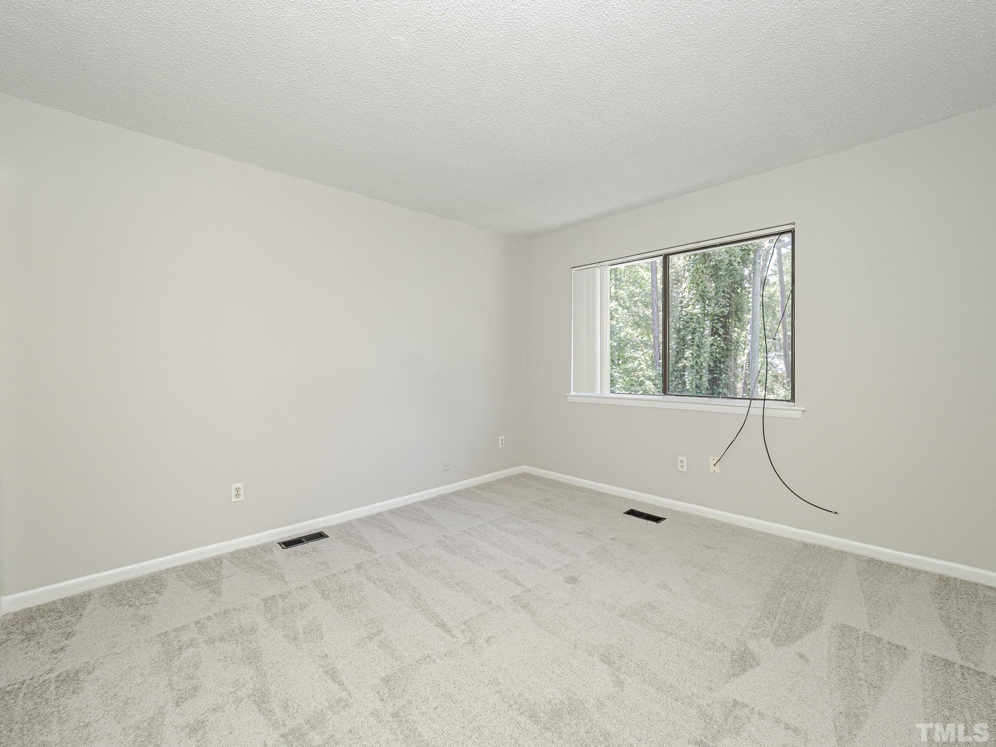 4705 Walden Pond Drive, Unit D Raleigh, NC 27604 - Photo 18 of 24 an empty room with a window