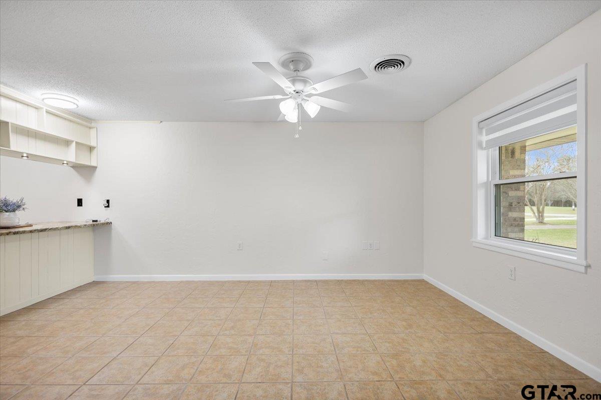 2320 Grangeway Road Marshall, TX 75672 - Photo 13 of 48 an empty room with a window and a ceiling fan
