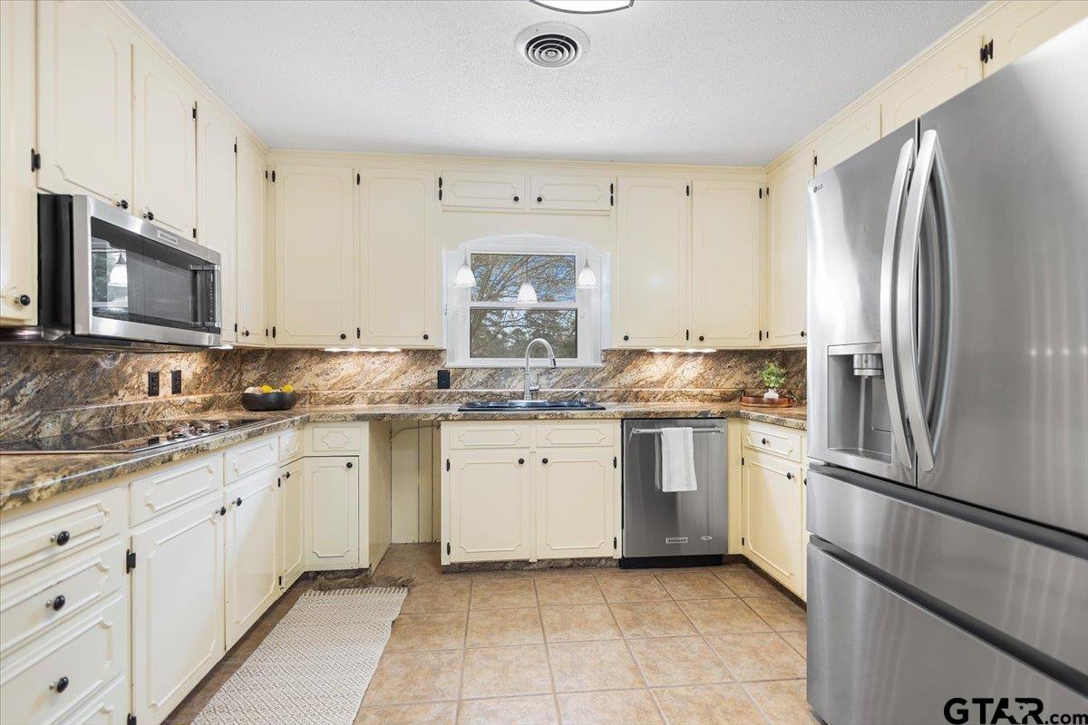 2320 Grangeway Road Marshall, TX 75672 - Photo 15 of 48 a kitchen with a sink stove and refrigerator