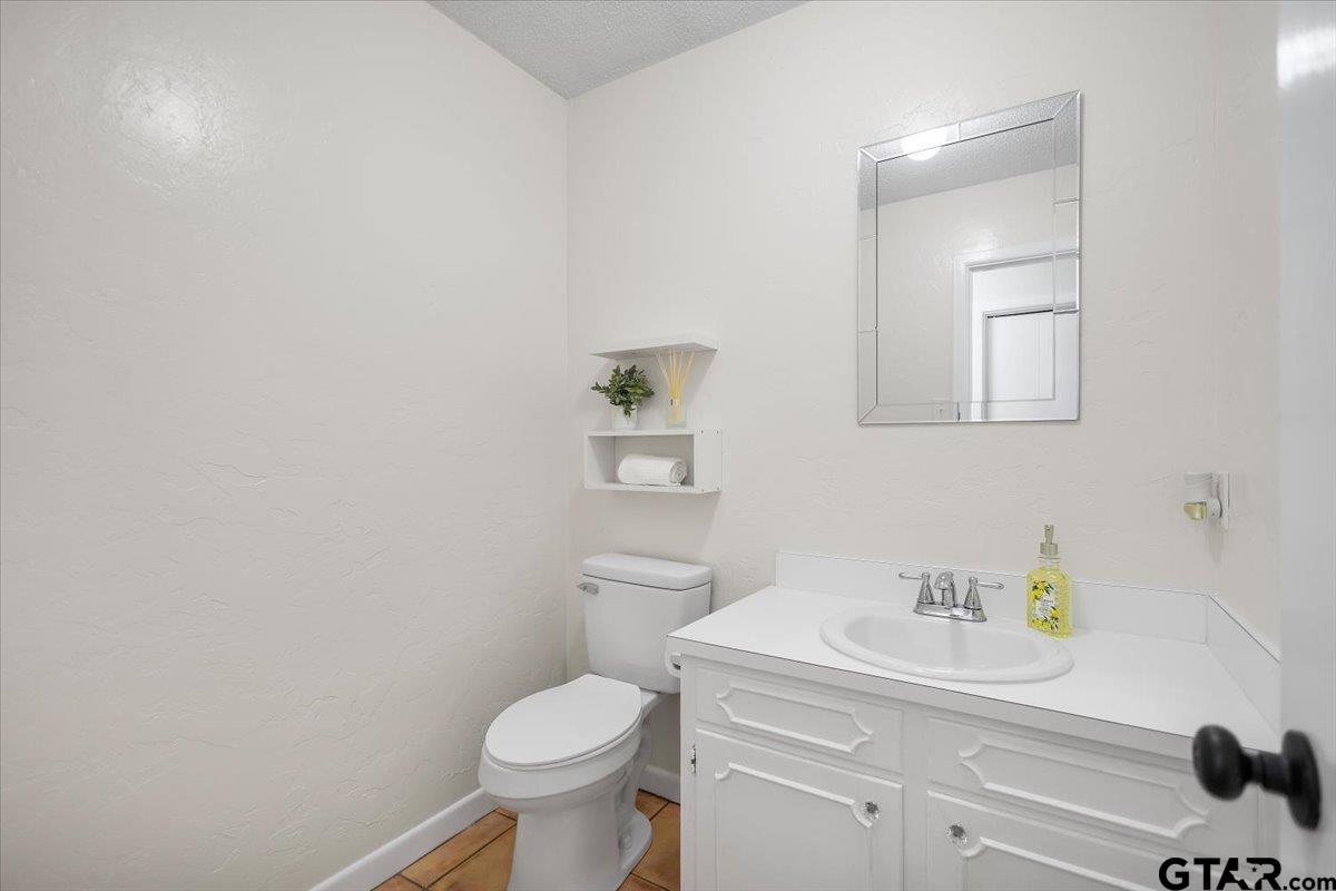 2320 Grangeway Road Marshall, TX 75672 - Photo 18 of 48 a bathroom with a sink a toilet and a mirror