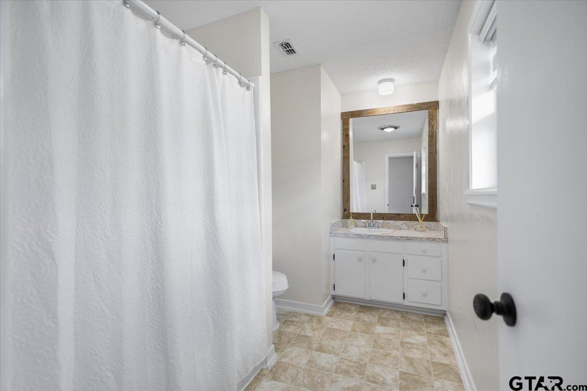 2320 Grangeway Road Marshall, TX 75672 - Photo 21 of 48 a bathroom with a sink and a mirror