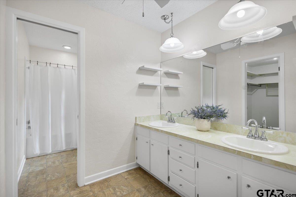 2320 Grangeway Road Marshall, TX 75672 - Photo 23 of 48 a bathroom with a double vanity sink and a mirror