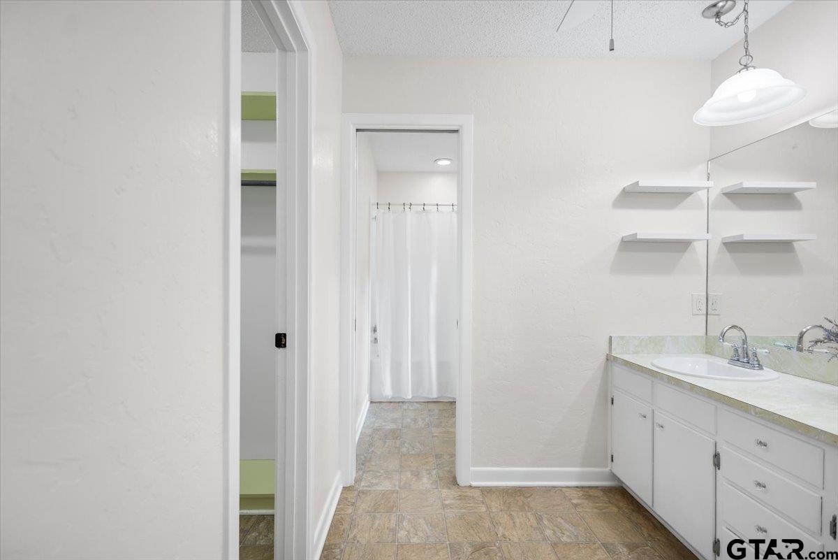 2320 Grangeway Road Marshall, TX 75672 - Photo 24 of 48 a bathroom with a sink and a mirror