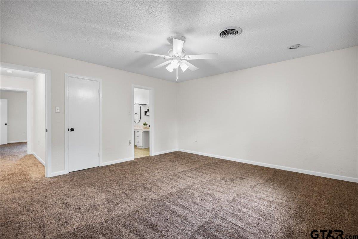 2320 Grangeway Road Marshall, TX 75672 - Photo 32 of 48 a view of an empty room and chandelier fan