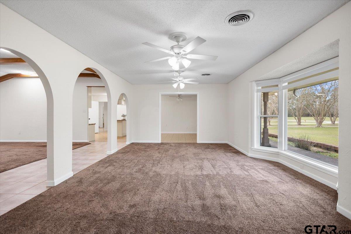 2320 Grangeway Road Marshall, TX 75672 - Photo 9 of 48 a view of empty room with wooden floor and fan