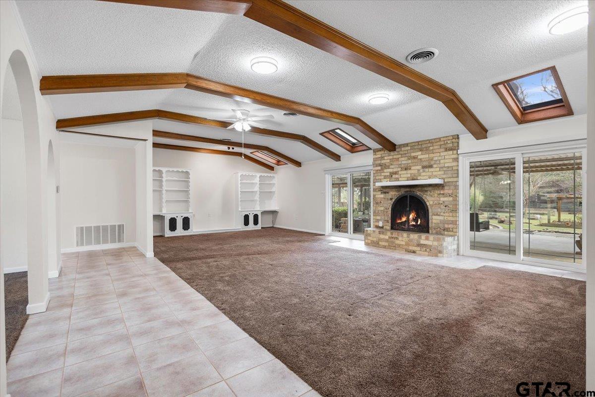 2320 Grangeway Road Marshall, TX 75672 - Photo 10 of 48 a view of empty room with fireplace and fan