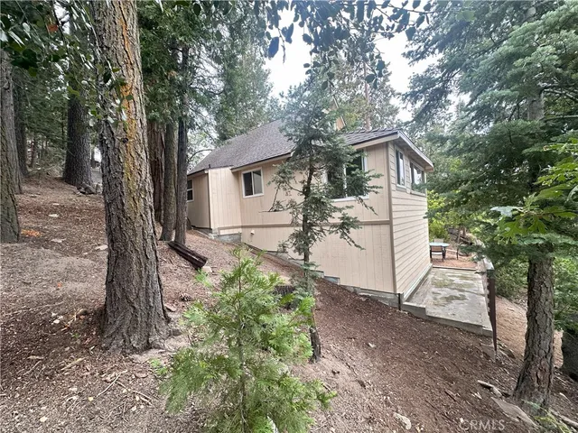a view of a house with a tree in the yard