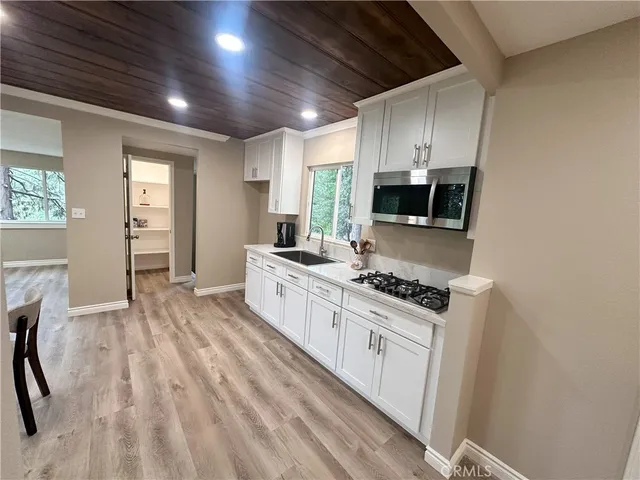 a kitchen with sink stove and refrigerator