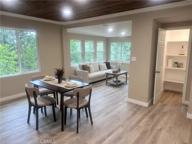a view of a dining room with furniture window and wooden floor