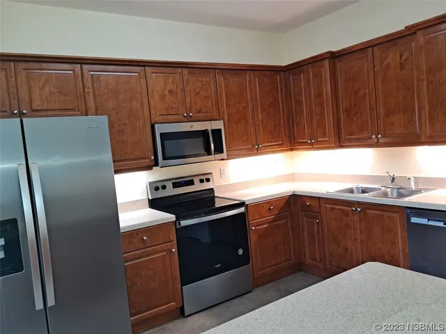 a kitchen with a sink appliances and cabinets