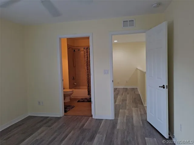 a view of a room with wooden floor