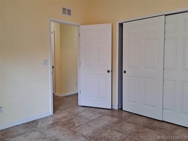 an empty room with closet area