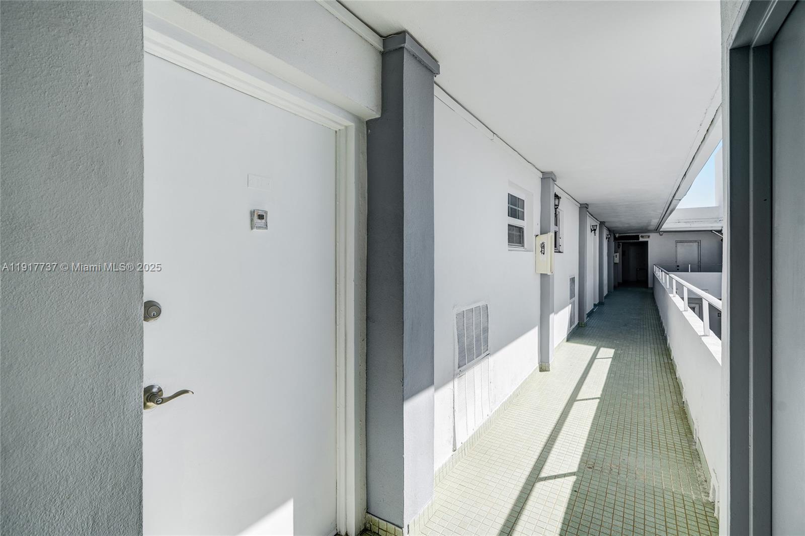 8000 Harding Avenue, Unit 7F Miami Beach, FL 33141 - Photo 23 of 46 a hallway with white doors wooden floor and stairs