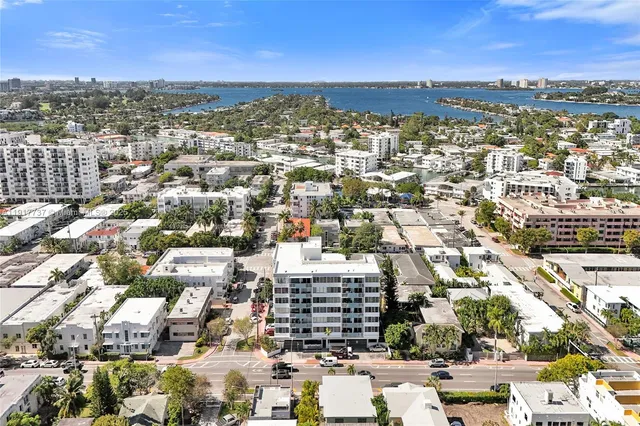 an aerial view of residential houses with city view
