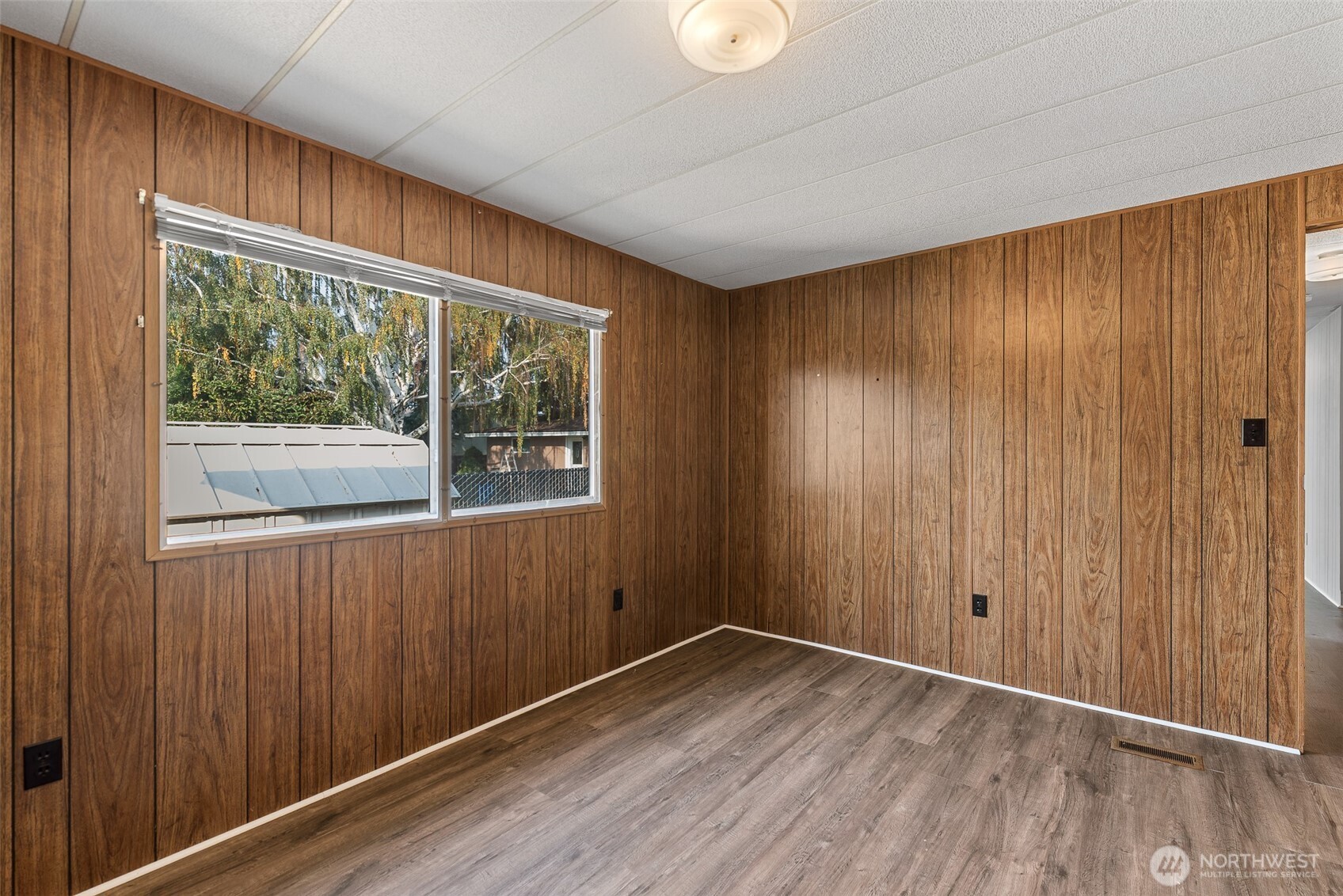 1608 North Western Avenue, Unit 3 Wenatchee, WA 98801 - Photo 20 of 26 an empty room with wooden floor and windows