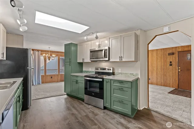 a kitchen with stainless steel appliances granite countertop a stove and a refrigerator
