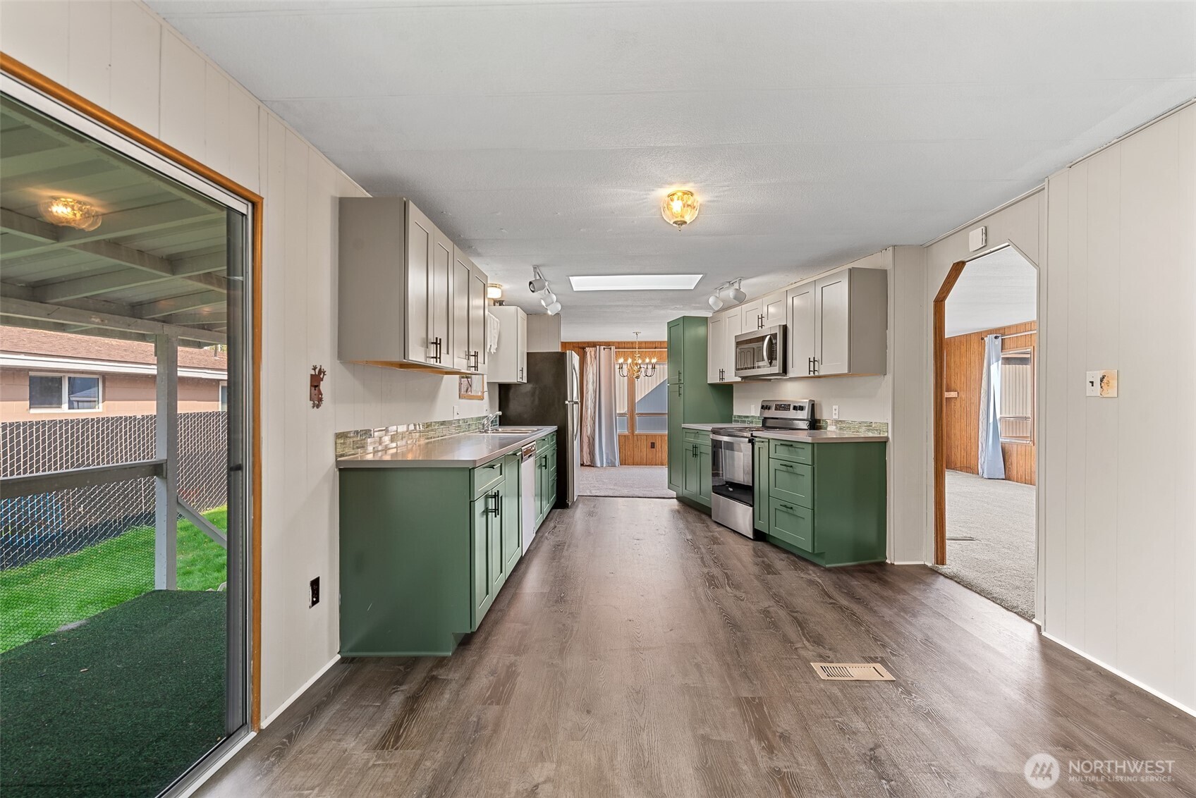 1608 North Western Avenue, Unit 3 Wenatchee, WA 98801 - Photo 10 of 26 a kitchen with stainless steel appliances kitchen island granite countertop a refrigerator a sink and a stove