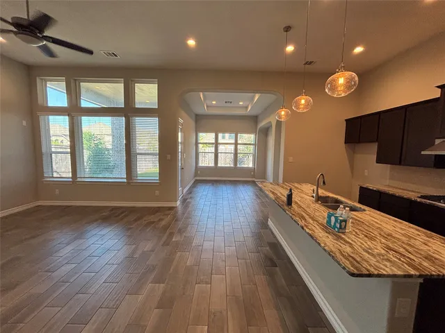 a view of empty room with wooden floor and fireplace